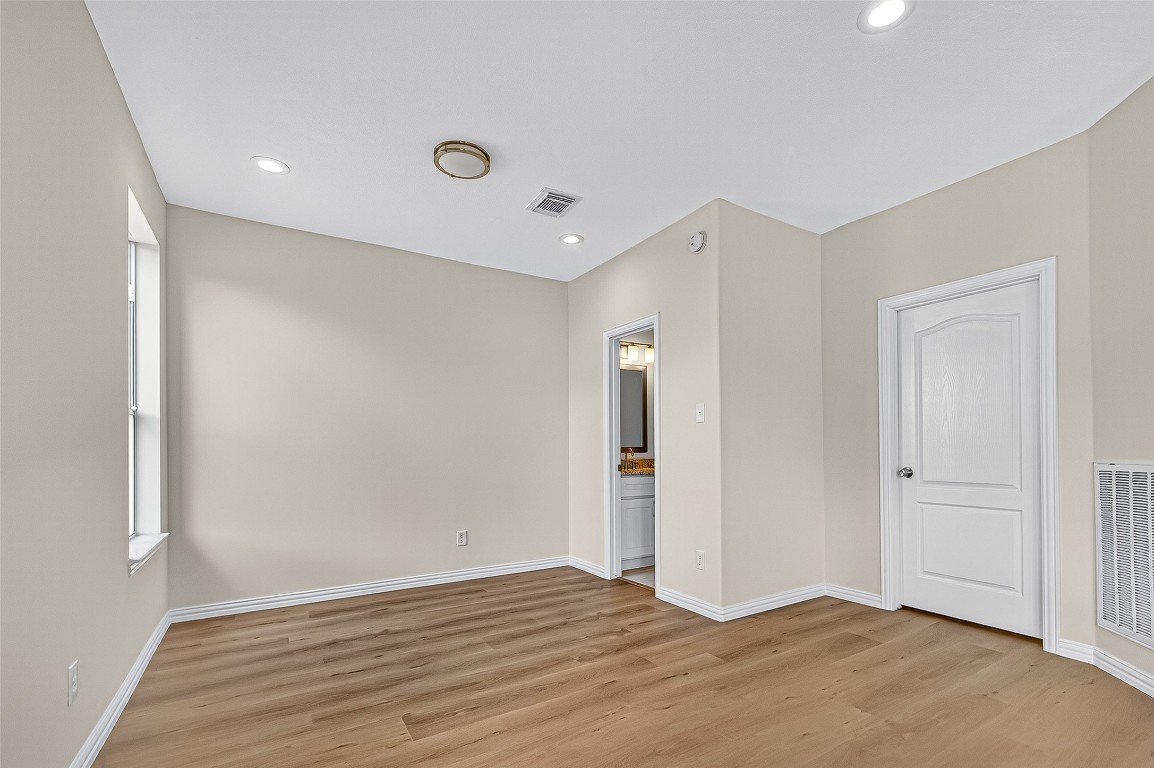 21310 Timber Pines Drive Spring, TX 77388 - Photo 14 of 49 an empty room with wooden floor and windows