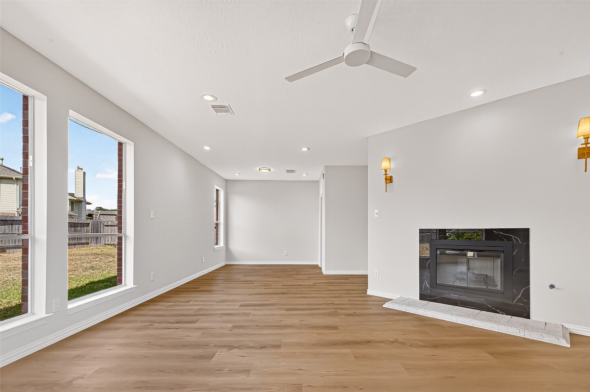 21310 Timber Pines Drive Spring, TX 77388 - Photo 19 of 49 a view of empty room with wooden floor and fireplace