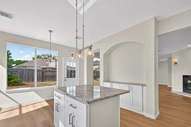 a kitchen with a table and chairs