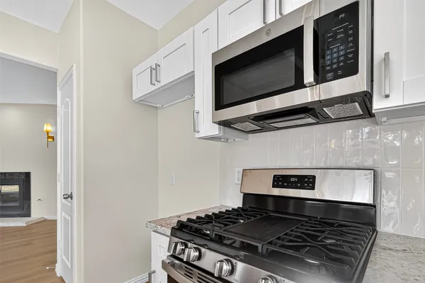 a stove top oven sitting inside of a kitchen