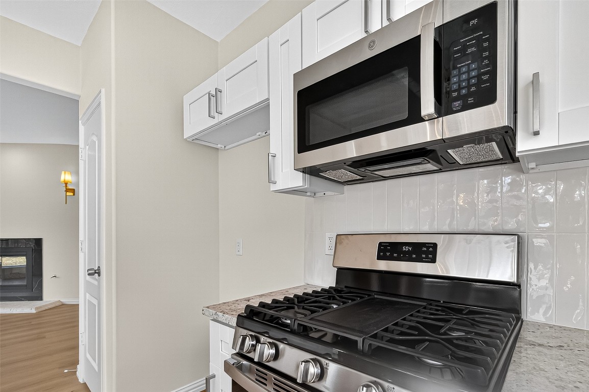 21310 Timber Pines Drive Spring, TX 77388 - Photo 25 of 49 a stove top oven sitting inside of a kitchen
