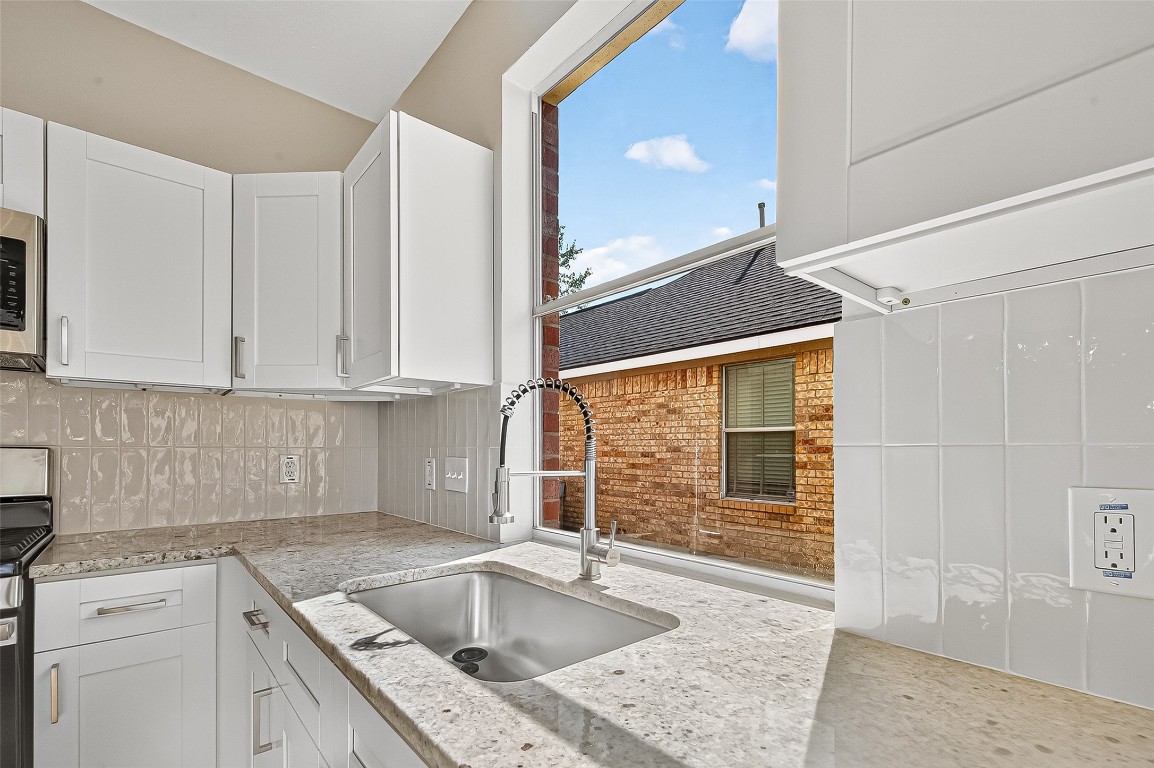 21310 Timber Pines Drive Spring, TX 77388 - Photo 26 of 49 a kitchen that has a sink and a stove in it