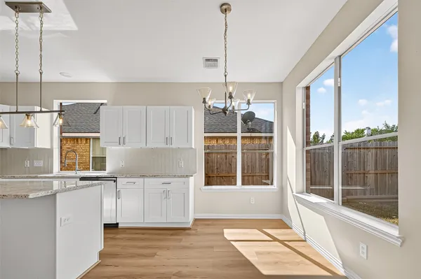 a view of a kitchen with a sink and windows
