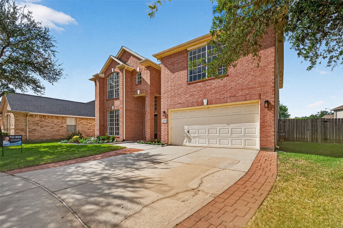 21310 Timber Pines Drive Spring, TX 77388 - Photo 3 of 49 a front view of a house with a yard and garage