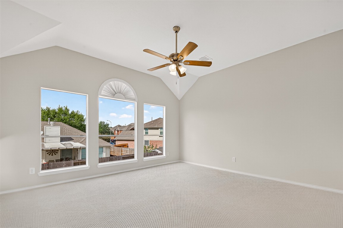 21310 Timber Pines Drive Spring, TX 77388 - Photo 34 of 49 an empty room with windows and ceiling fan