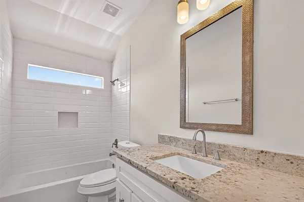 an empty room with a window and a ceiling fan