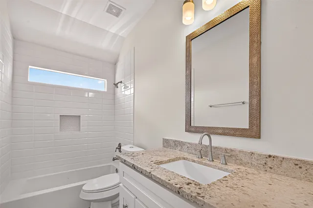 an empty room with a window and a ceiling fan