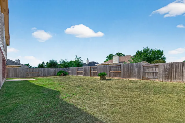 a view of a garden with a house in the background