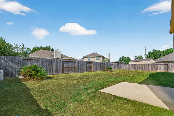 a view of a house with a yard and table and chairs