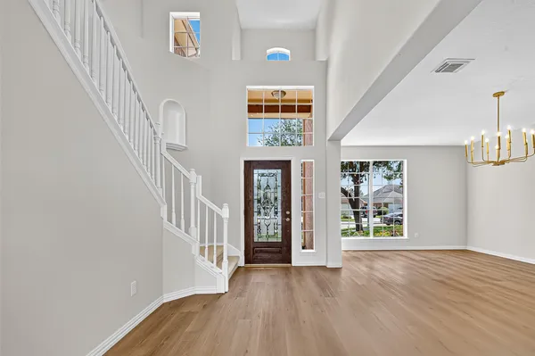a view of an entryway with wooden floor