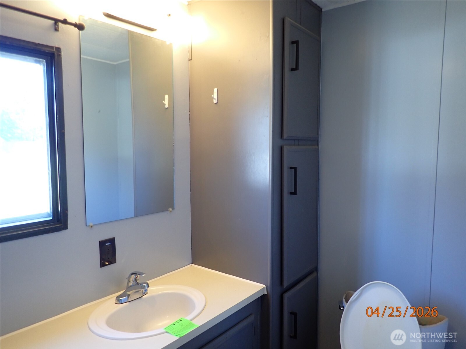 9217 183rd Avenue Southwest Rochester, WA 98579 - Photo 21 of 26 a bathroom with a sink a mirror and a toilet