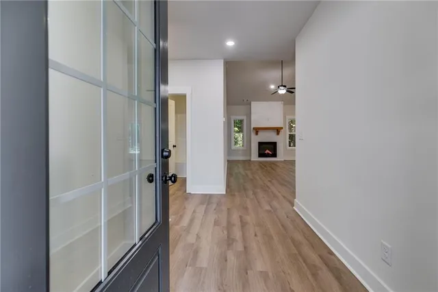 view of a hallway with wooden floor and staircase
