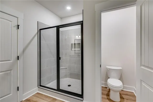 a bathroom with a toilet and a shower