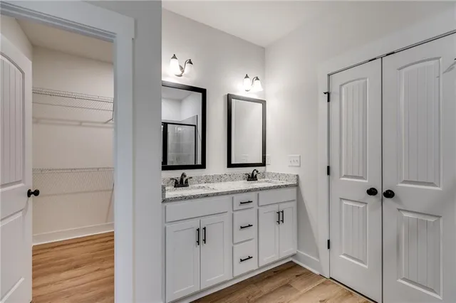 a bathroom with a double vanity sink and mirror