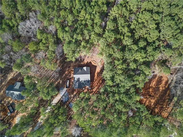 an aerial view of a house with a yard
