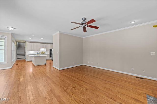 a view of a living room hardwood floor and a ceiling fan