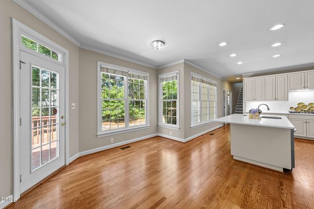 a view of open kitchen with wooden floor and outdoor space