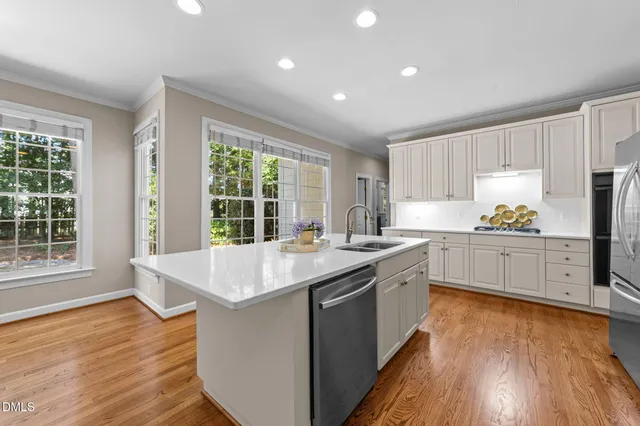 a kitchen with sink cabinets and wooden floor