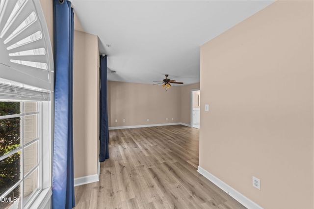 a view of a room with wooden floor