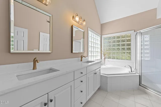 a bathroom with a tub sink and mirror