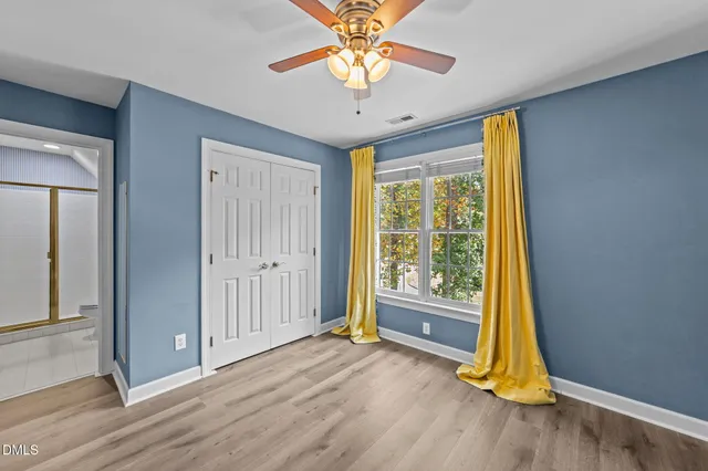 a view of a room with wooden floor and a window