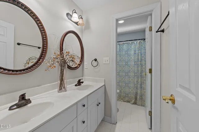 a bathroom with a double vanity sink and a mirror