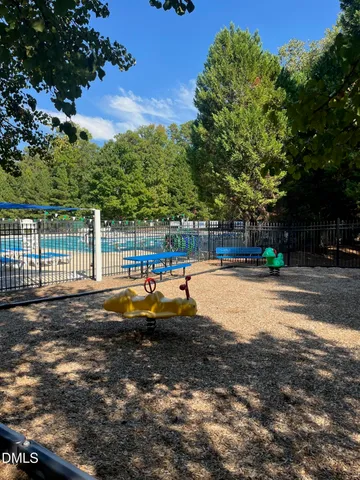a view of a playground with a house