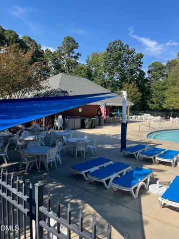 a view of a patio with table and chairs and potted plants