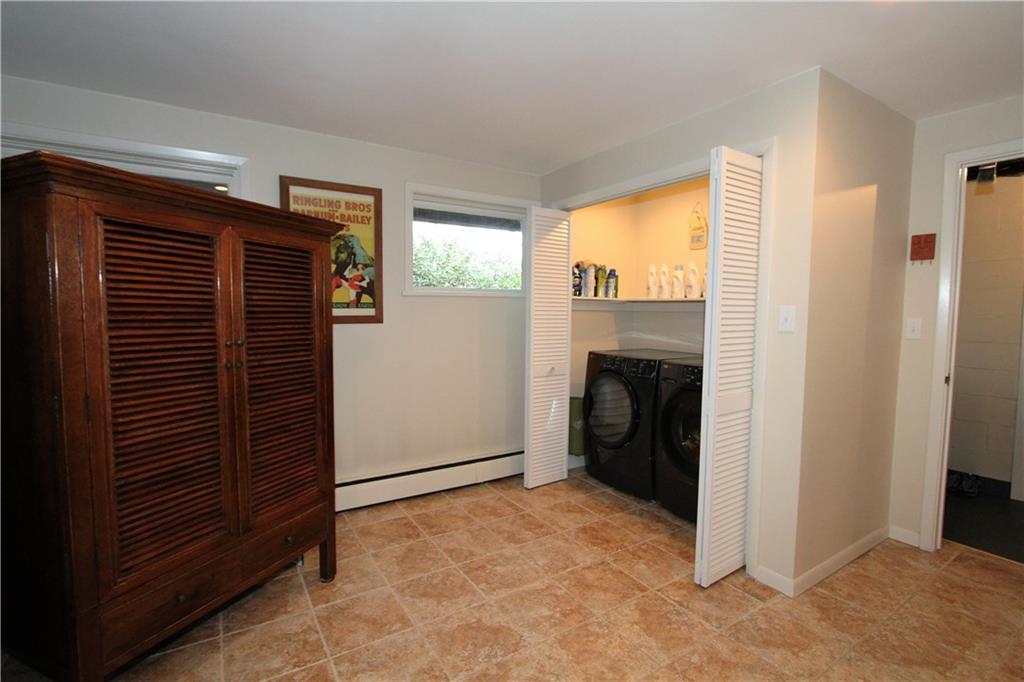 245 Tech Road Thornburg, PA 15205 - Photo 25 of 25 Large lower level ceramic tiled room with laundry area. Washer and dryer included! Large full bath off of this room. Also access to mud room and garage.