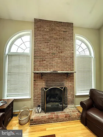 a living room with fireplace furniture and a floor to ceiling window