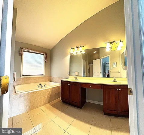 a large bathroom with a large tub and sink