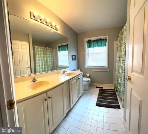 a bathroom with a granite countertop sink and a bathtub