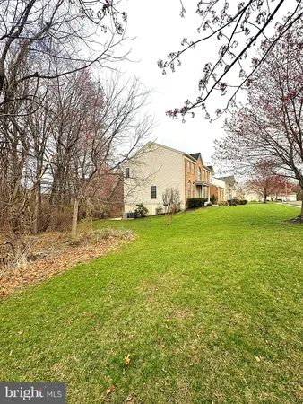 a view of a yard with a house in the background