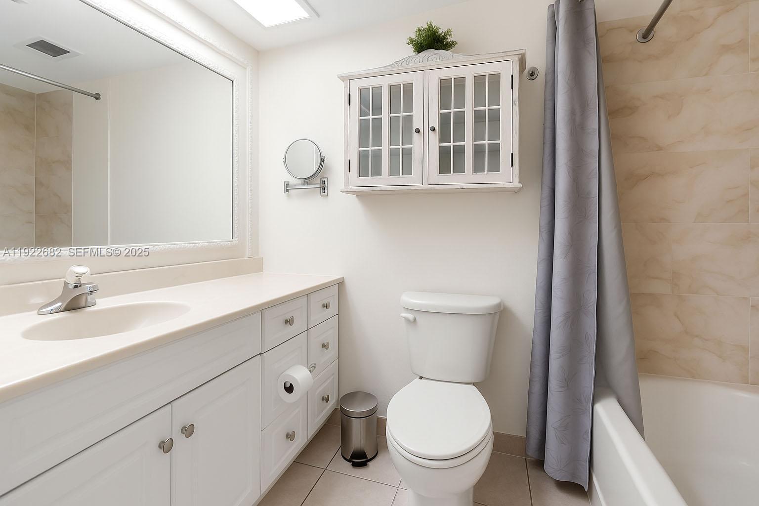 2300 Southwest 22nd Avenue, Unit 109 Delray Beach, FL 33445 - Photo 17 of 49 a bathroom with a toilet a sink and a bathtub