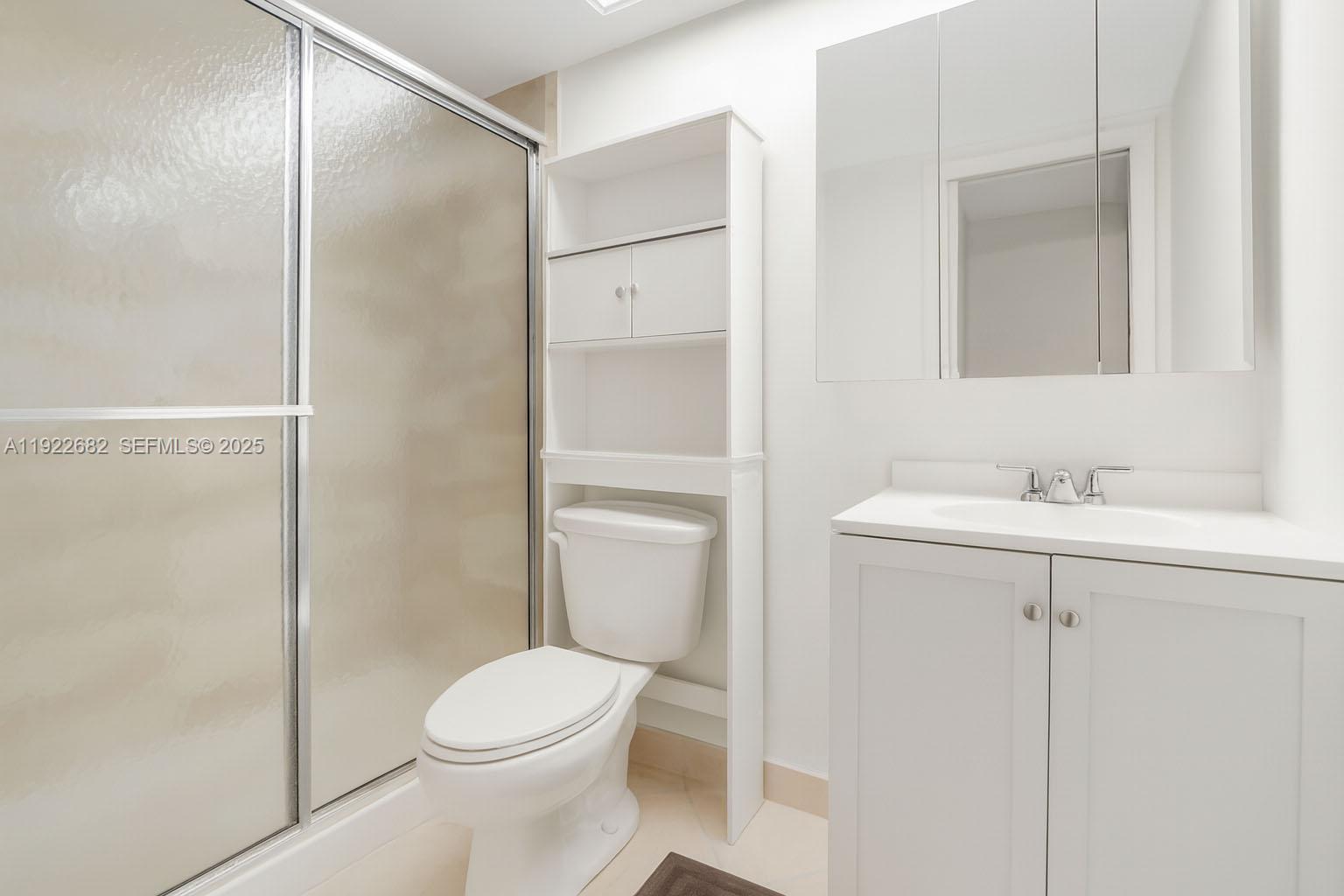 2300 Southwest 22nd Avenue, Unit 109 Delray Beach, FL 33445 - Photo 19 of 49 a bathroom with a sink a toilet and shower