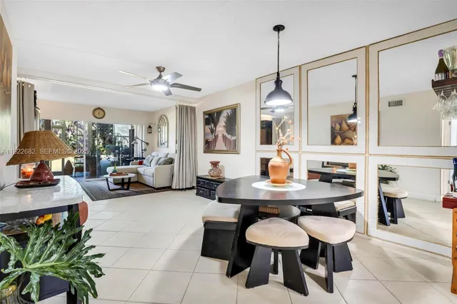 a view of a dining room with furniture and chandelier