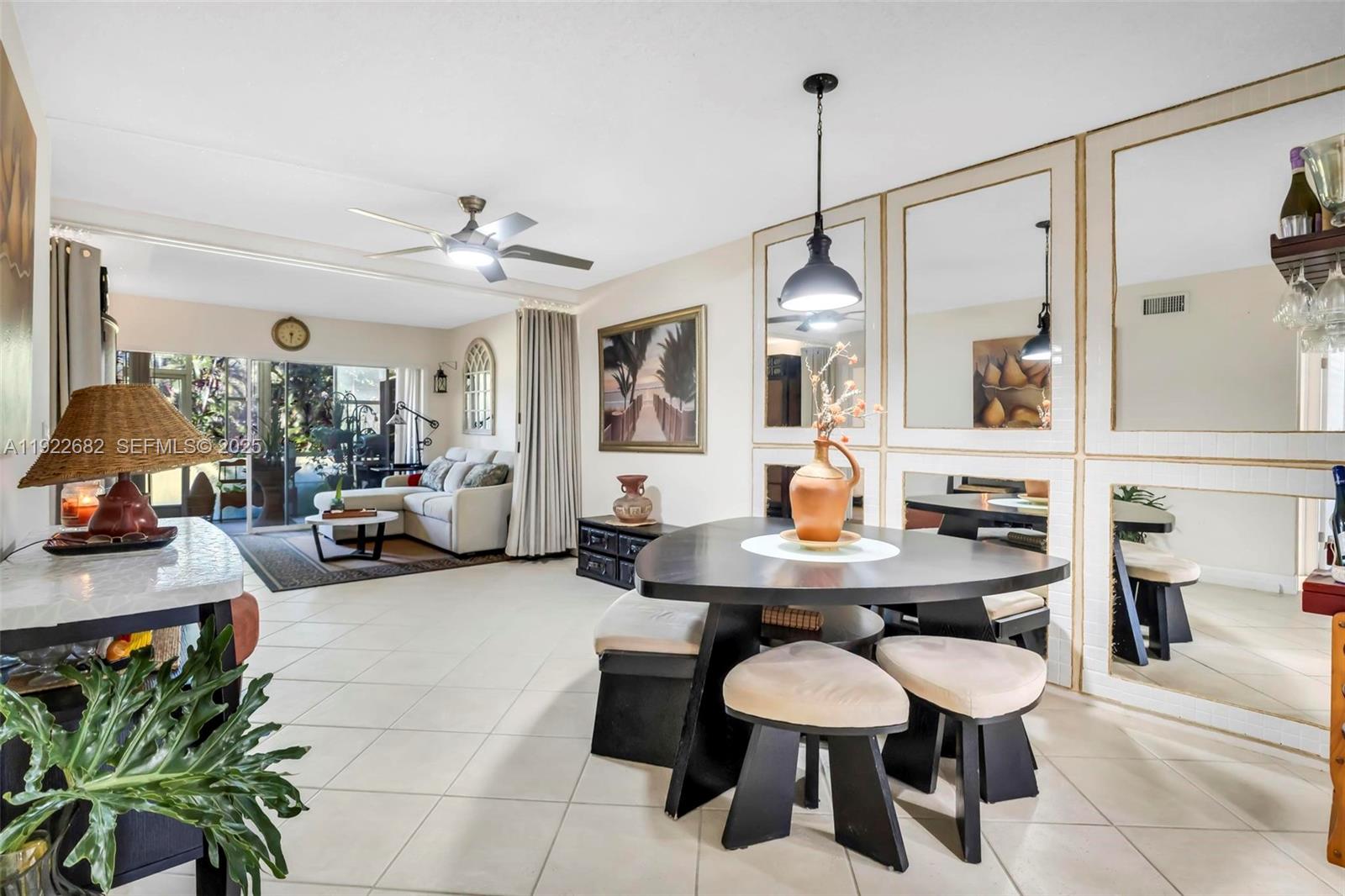2300 Southwest 22nd Avenue, Unit 109 Delray Beach, FL 33445 - Photo 2 of 49 a view of a dining room with furniture and chandelier