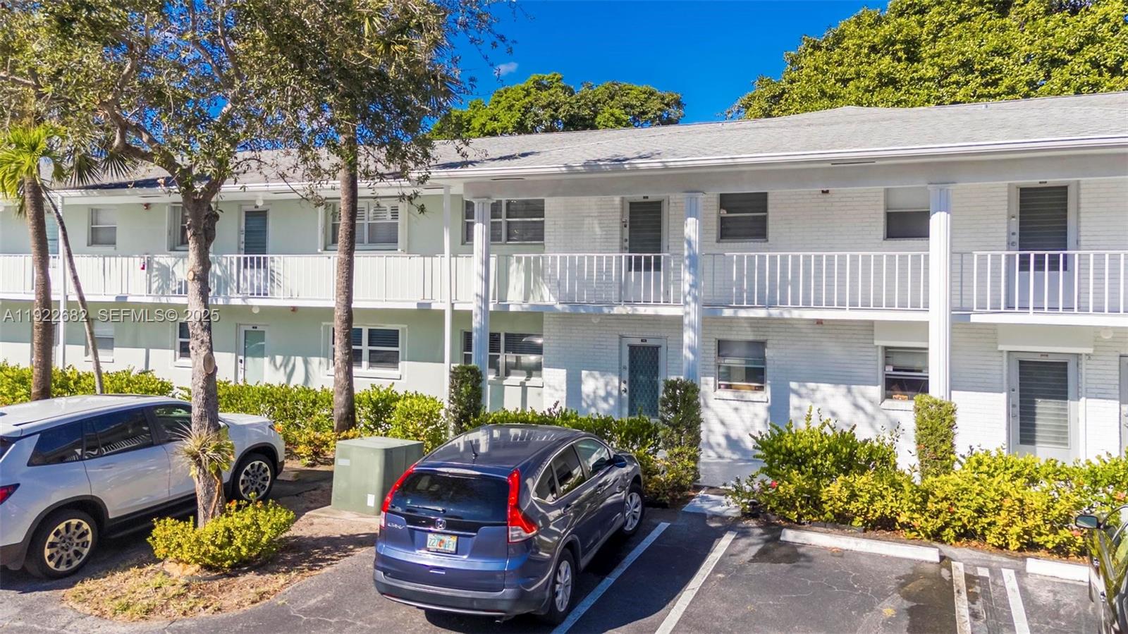 2300 Southwest 22nd Avenue, Unit 109 Delray Beach, FL 33445 - Photo 22 of 49 a view of a patio with couches table and chairs and potted plants