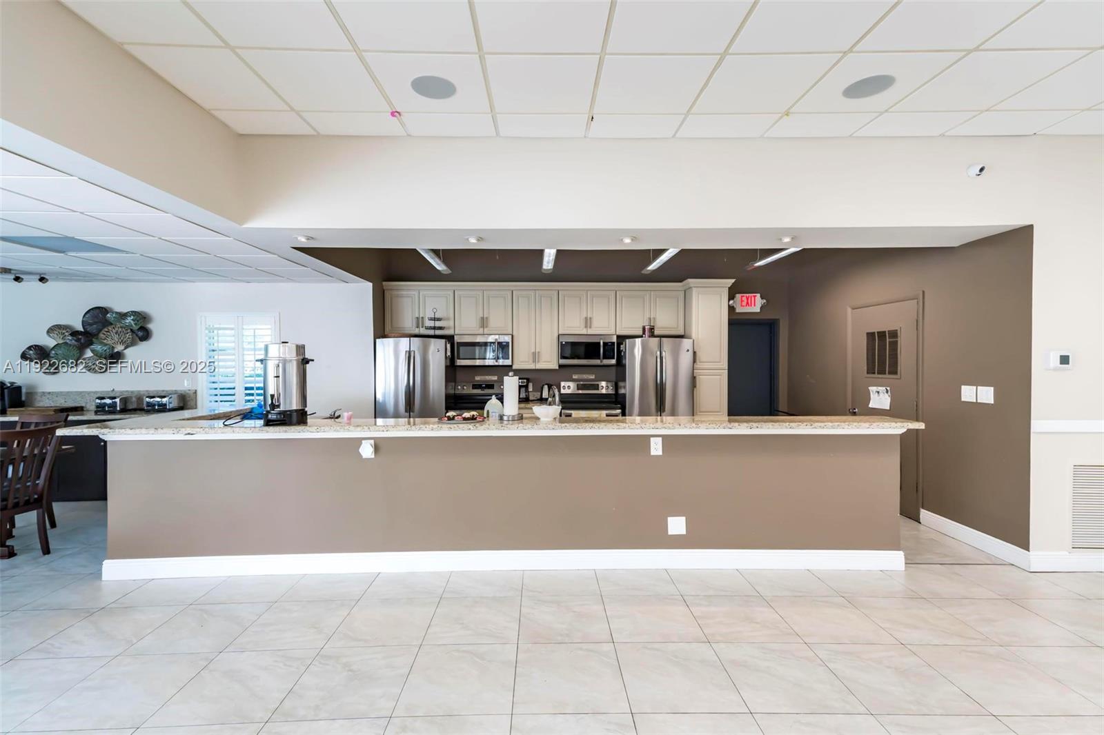 2300 Southwest 22nd Avenue, Unit 109 Delray Beach, FL 33445 - Photo 46 of 49 a living room with stainless steel appliances furniture and kitchen view