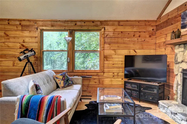 a view of a hallway with wooden floor and a bookshelf