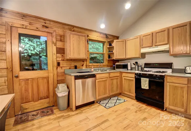 a kitchen with stainless steel appliances granite countertop a refrigerator and a stove top oven