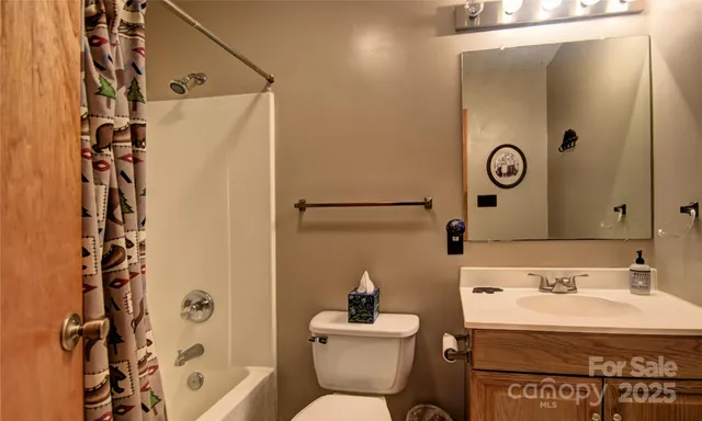 a spacious bedroom with a bed and a chandelier