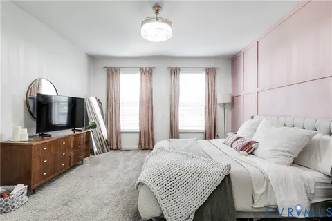 a bedroom with a bed and a painting on the wall