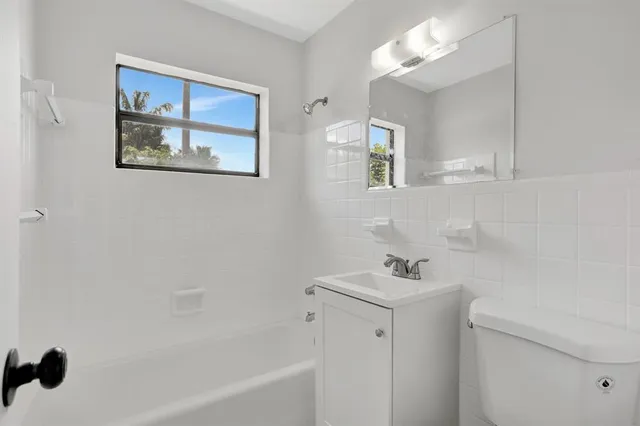 a bathroom with a sink a mirror and a bathtub