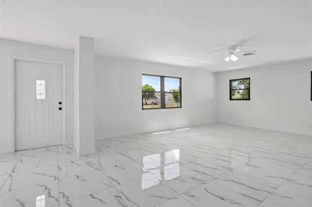 a view of a big room with windows and cabinet