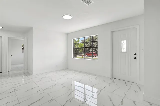 an empty room with windows and closet