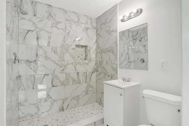 a bathroom with a sink toilet and shower