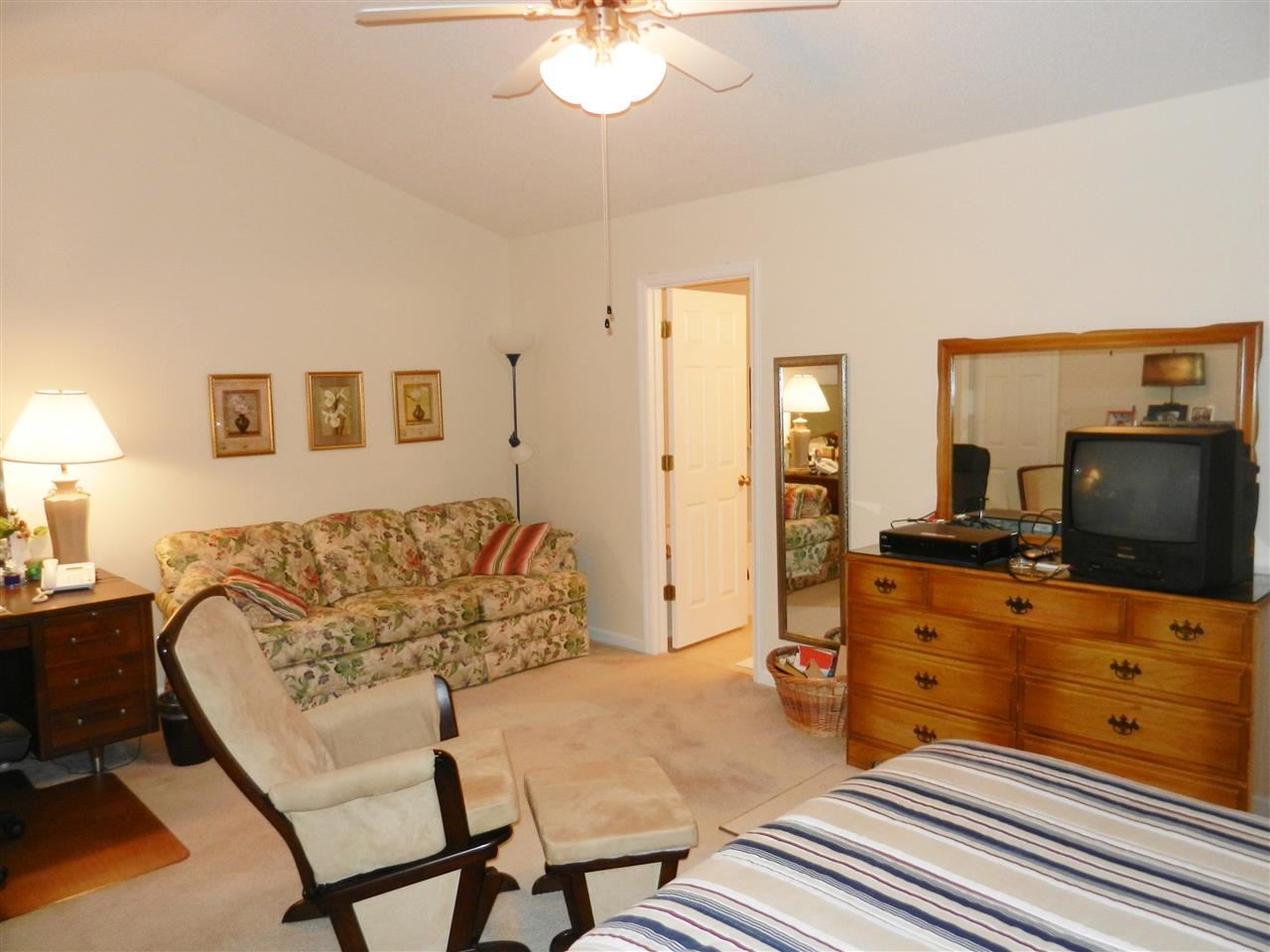 245 Saddle Ridge Drive Willow Spring, NC 27592 - Photo 16 of 24 a living room with furniture and a flat screen tv