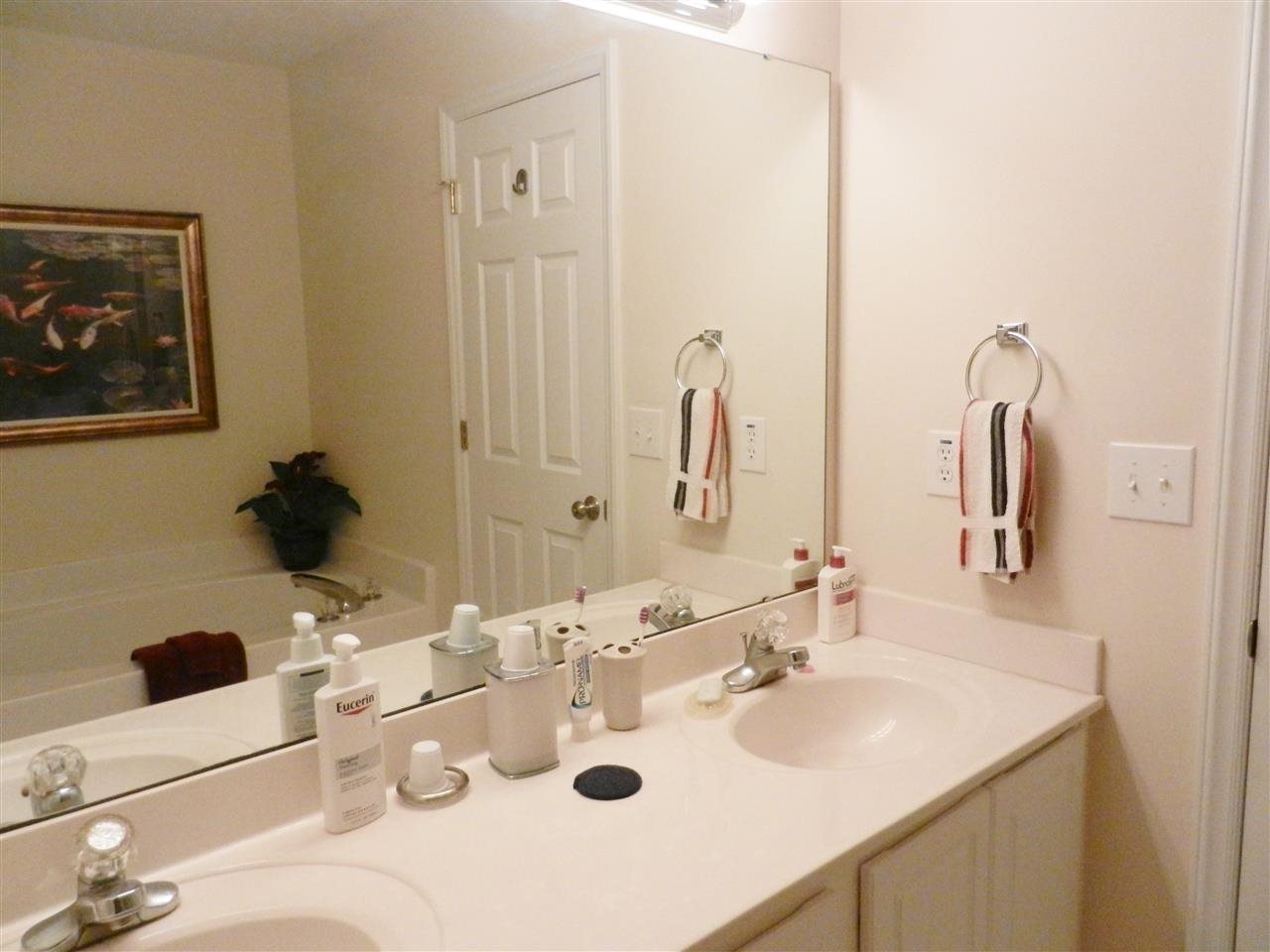 245 Saddle Ridge Drive Willow Spring, NC 27592 - Photo 18 of 24 a bathroom with a sink and a mirror