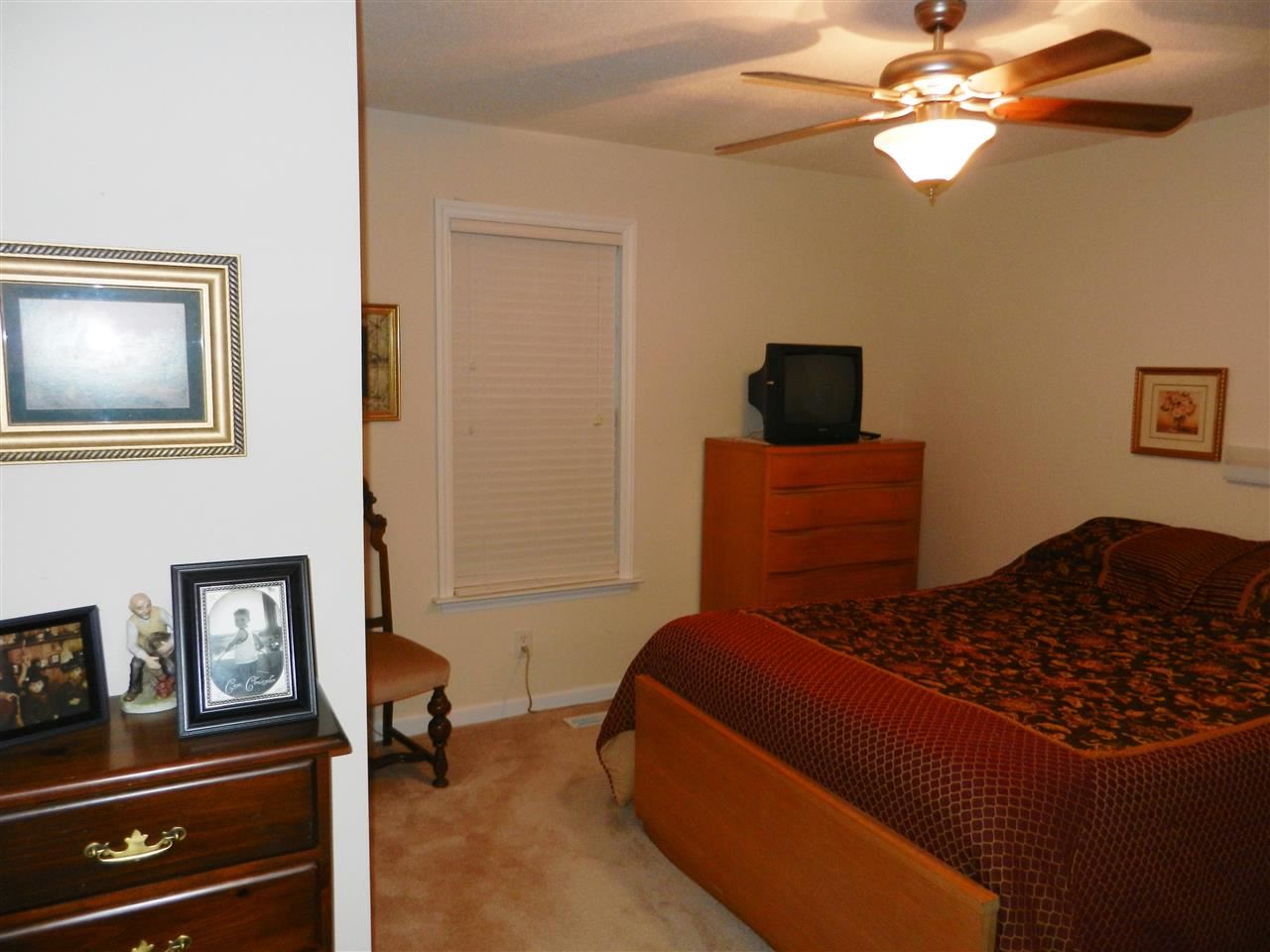 245 Saddle Ridge Drive Willow Spring, NC 27592 - Photo 20 of 24 a bedroom with a bed and a chandelier